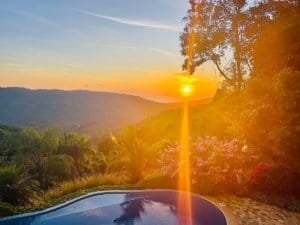Sunset over lush hills and tropical garden in Dominical, Costa Rica.