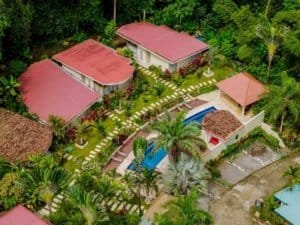 Aerial view of a private villa with pools and lush gardens in Dominical, Costa Rica.