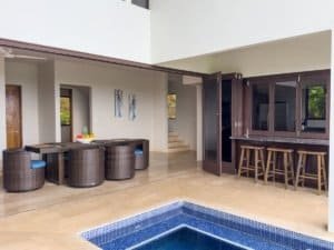 Modern outdoor living space with pool, bar, and seating area in Dominical.