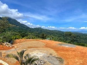 Fenced land with ocean view, tropical forest, and mountain backdrop in Dominical.