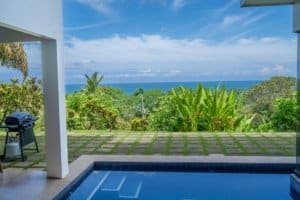 Stunning ocean view from a luxury home with pool and lush garden in Dominical.