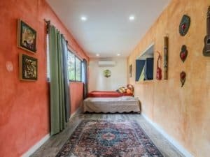 Bright bedroom with colorful walls, window view, and musical decor.