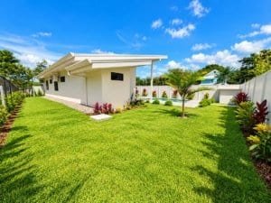 Dominical style modern home with private pool and lush tropical lawn in Costa Rica.