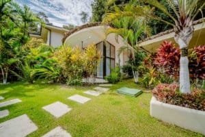 Lush tropical garden with stepping stones and vibrant plants in Dominical Costa Rica.