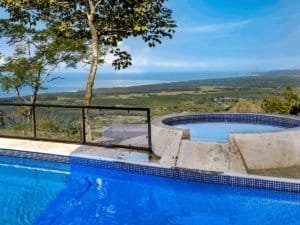 Infinity pool with ocean view and tropical rainforest in Dominical.