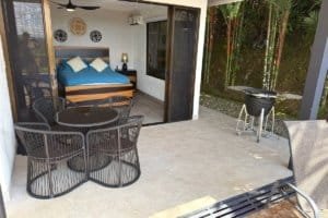 Patio and outdoor dining area with view into a bedroom in a Costa Rica home.