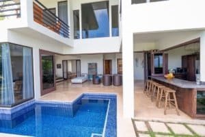 Modern Costa Rica home with private pool, outdoor seating, and ocean view.