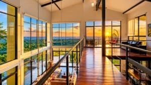 Interior living area with large glass windows and sunset ocean panorama in Dominical.