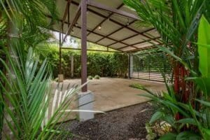 Dominical real estate: turn-key 2 bed coastal home with carport and tropical landscaping.