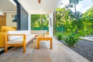 Dominical real estate: covered patio with seating and lush greenery view.