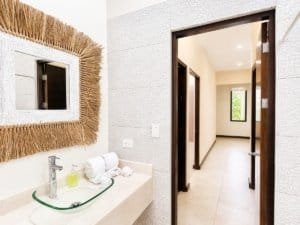 Contemporary bathroom with glass sink and decorative mirror in Costa Rica.