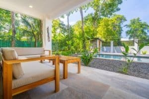 Ocean view porch with lounge seating and pool in Costa Rica real estate.