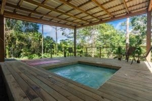 Dominical area deck with pool, trees and covered patio in Costa Rica real estate.