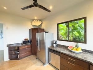 Modern kitchen with granite counters and ocean view in Dominical.