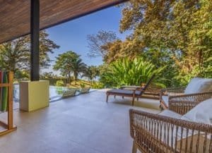 Ocean view terrace with lounge chairs and lush tropical greenery in Costa Rica.