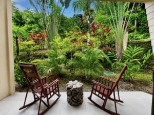 Relaxing garden view with chairs and lush tropical plants in Dominical.