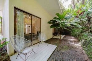 Relaxing outdoor patio of a Dominical villa with tropical plants and seating.