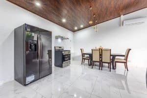 Spacious kitchen with stainless steel appliances and dining table in Costa Rica home.