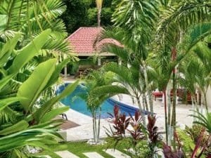 Lush tropical garden with pool and resort amenities in Dominical, Costa Rica.