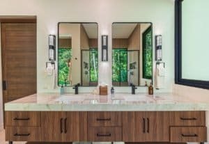 Dominical area luxury villa bathroom with double vanity and three mirrors.