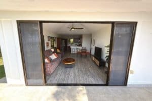 Panoramic living area with sofa, coffee table, and open kitchen in Dominical real estate.