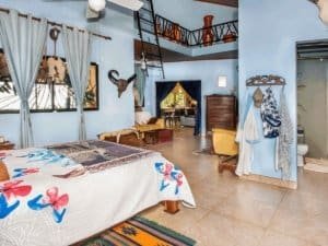 Spacious bedroom with tropical decor and high ceiling in Costa Rica estate.