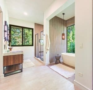 Modern bathroom with double vanity, spacious shower, and freestanding tub in bright, airy space.