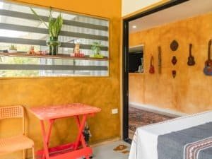 Vibrant yellow walls with decorative guitars and hearts in Costa Rica.