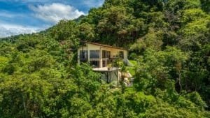 Secluded Costa Rica hillside home with ocean view among lush forest.