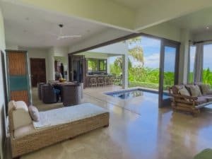 Spacious living room with pool and ocean view in Dominical, Costa Rica.