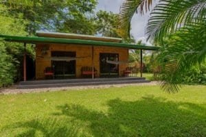 Dominical real estate: turn-key coastal home with veranda and tropical lawn.