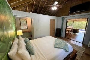 Interior view of a bedroom in a natural jungle home near Dominical with private pool access.