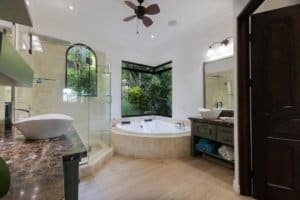 Elegant bathroom with bathtub, shower, and ocean view in Costa Rica.
