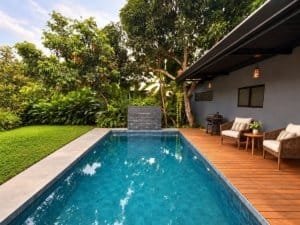 Beautiful tropical home with private pool and outdoor seating area near the beach.