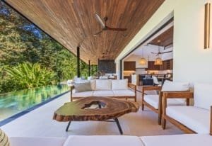 Ocean view villa terrace with modern seating and wooden coffee table in Costa Rica.