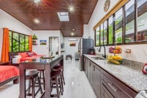 Spacious kitchen and living area with dark wood ceilings and modern finishes.