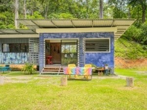 Colorful container home with terraces and lush green surroundings in Dominical.