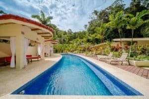 Luxury pool with lounge chairs and tropical landscaping in Dominical, Costa Rica.