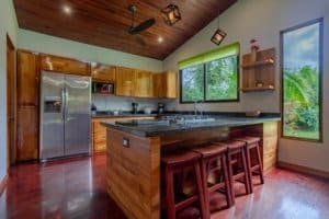 Turn-key 2-bedroom coastal kitchen with island and stools in Costa Rica.
