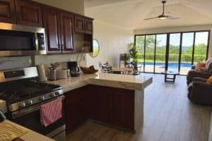 Cozy kitchen and living area with ocean view balcony in Dominical, Costa Rica.