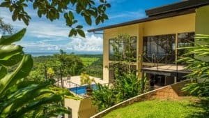 Panoramic ocean view home with pool and lush greenery in Dominical, Costa Rica.