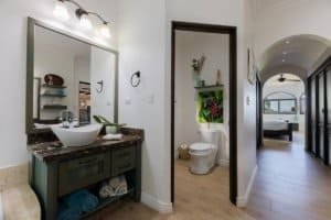 Modern bathroom with vessel sink, walk-in shower, and ocean view in Costa Rica.