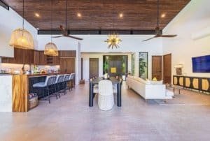 Spacious open-plan living and dining area with modern kitchen and tropical decor in Dominical area.