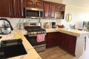 Modern kitchen in Costa Rica home with stainless steel appliances and marble countertops.