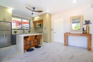 Bright modern kitchen with island and seating, ocean view in Dominical condo.