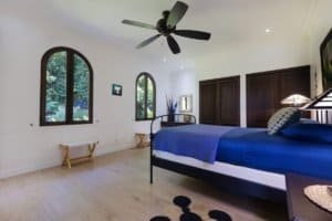 Spacious bedroom with mountain views, dark wood accents, and modern decor.