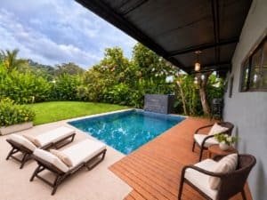 Relaxing outdoor pool area with lounge chairs and lush greenery in Dominical.