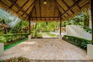 Tropical garden pavilion with stone floor and lush greenery in Dominical.