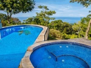 Luxury pool with ocean view and tropical rainforest in Dominical.