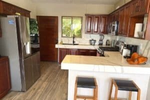 Fully equipped kitchen in Costa Rica home with stainless steel appliances and marble island.